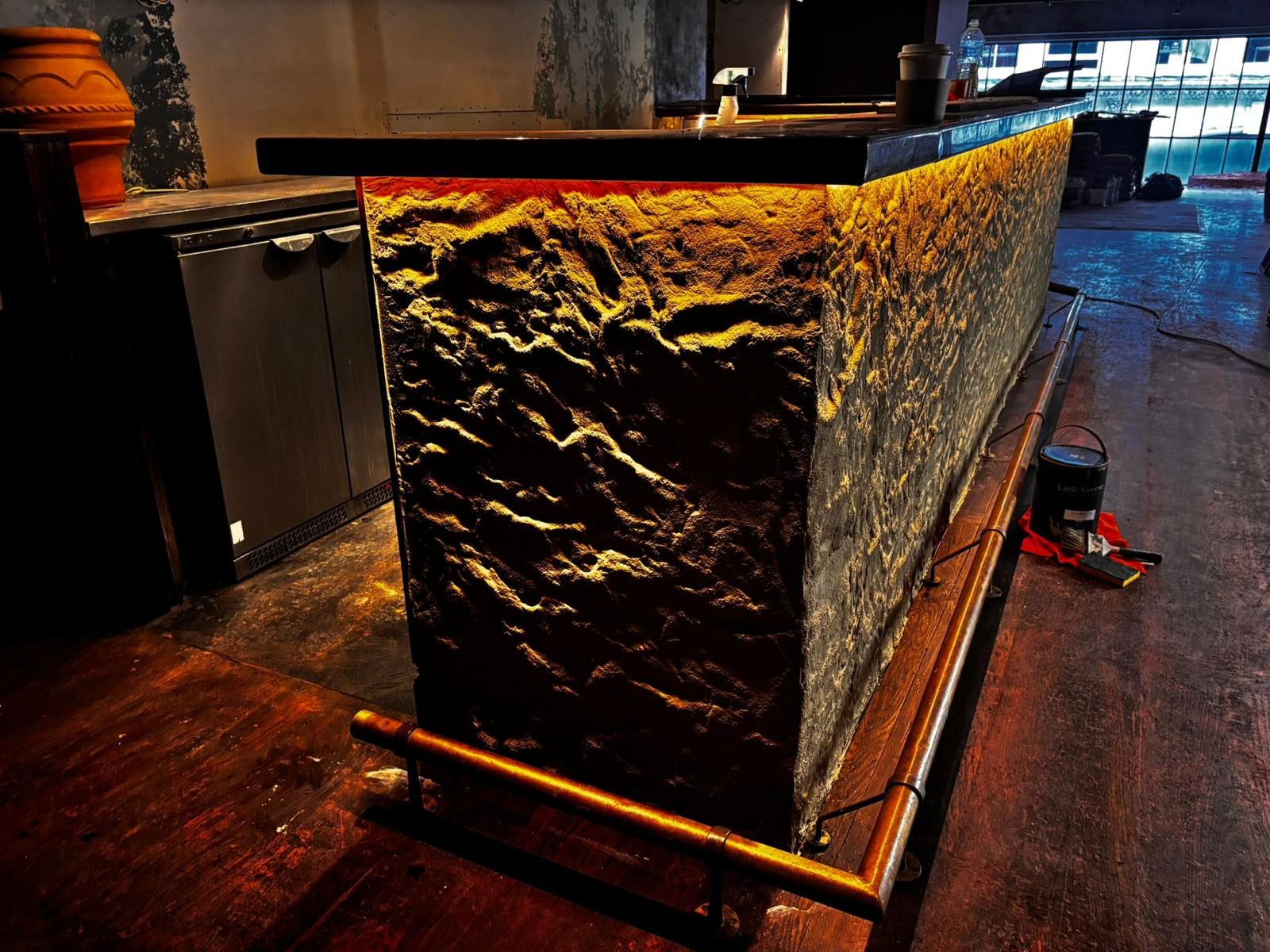 Dark stone bar with amber LED lighting