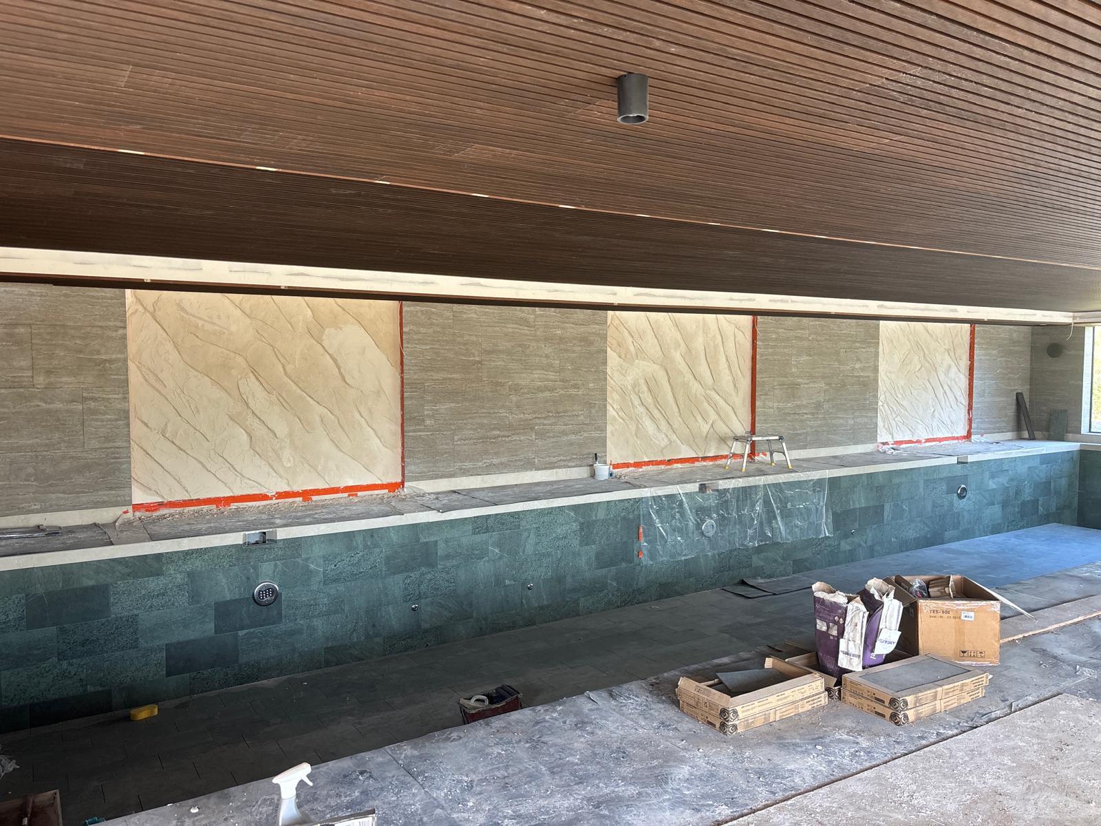 Handcrafted stone panels in luxury pool area
