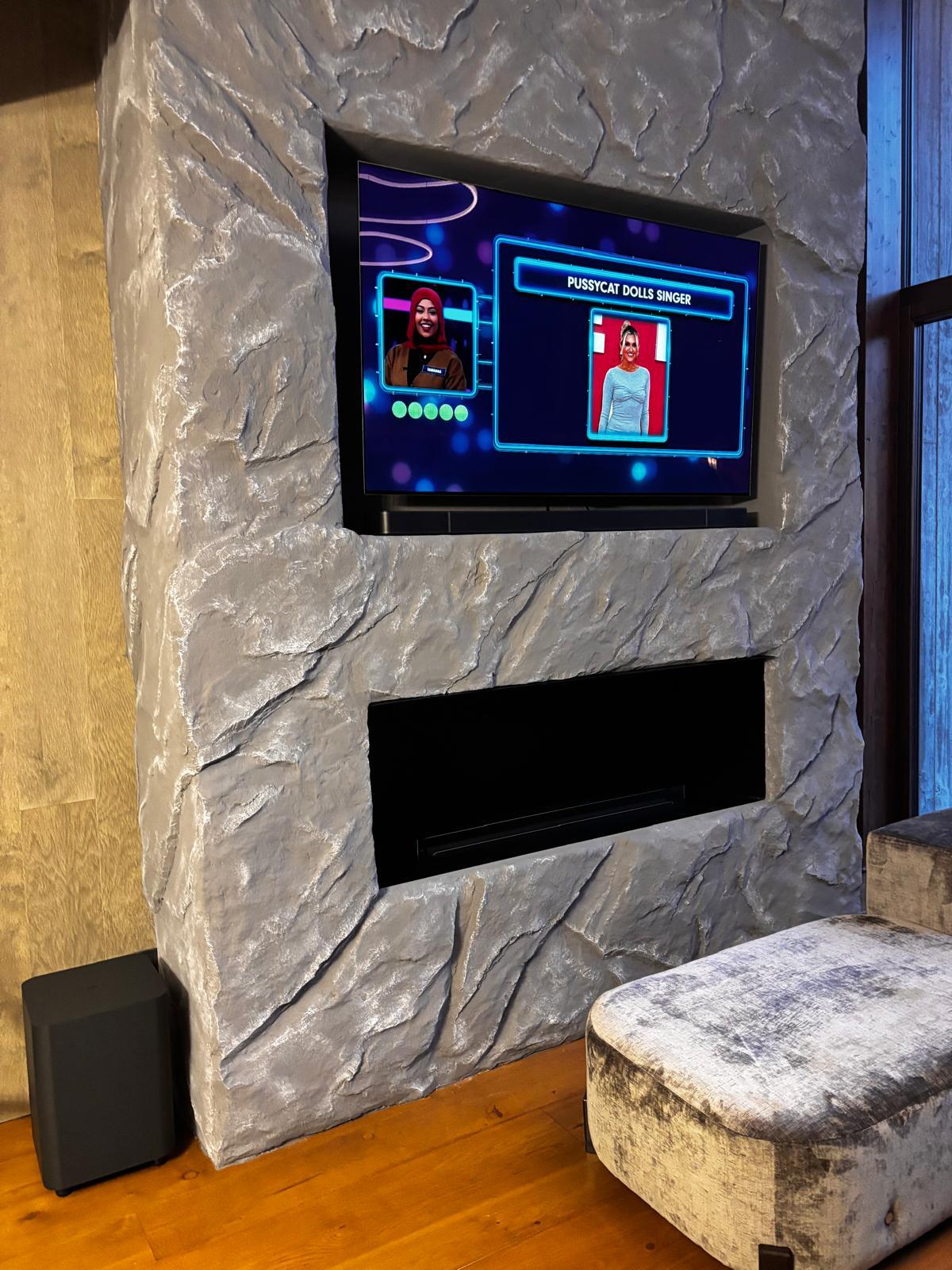 Stone fireplace surround with integrated TV