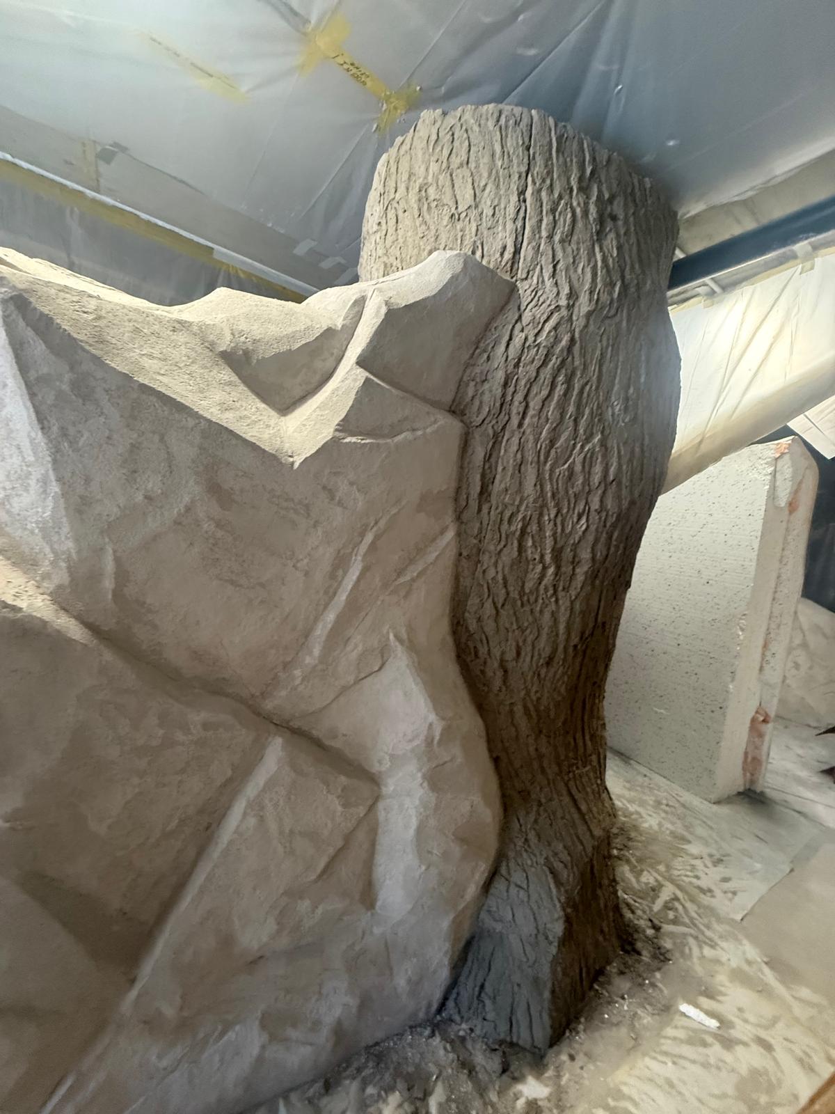 Large rock and tree trunk sculptural piece